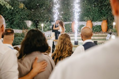 Abraço dos noivos com bolas de sabão e pirotecnia ao fundo em casamento captado por Humberto Barbosa em Santa Maria da Feira