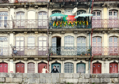 Noivos posam em varanda de edifício histórico — fotografia de casamento no Porto por Humberto Barbosa